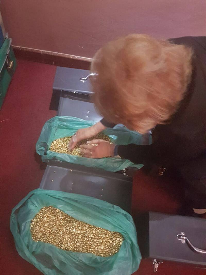 Fake gold nuggets from East Africa as grabbed by hands by one of naive believers